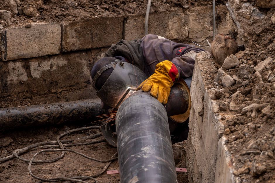 Technician inspecting a drain pipe in Cambridge before repair